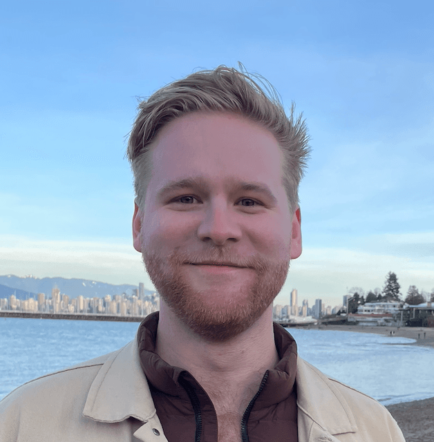 Johnathan Bryce smiling with a backdrop of Downtown Vancouver
